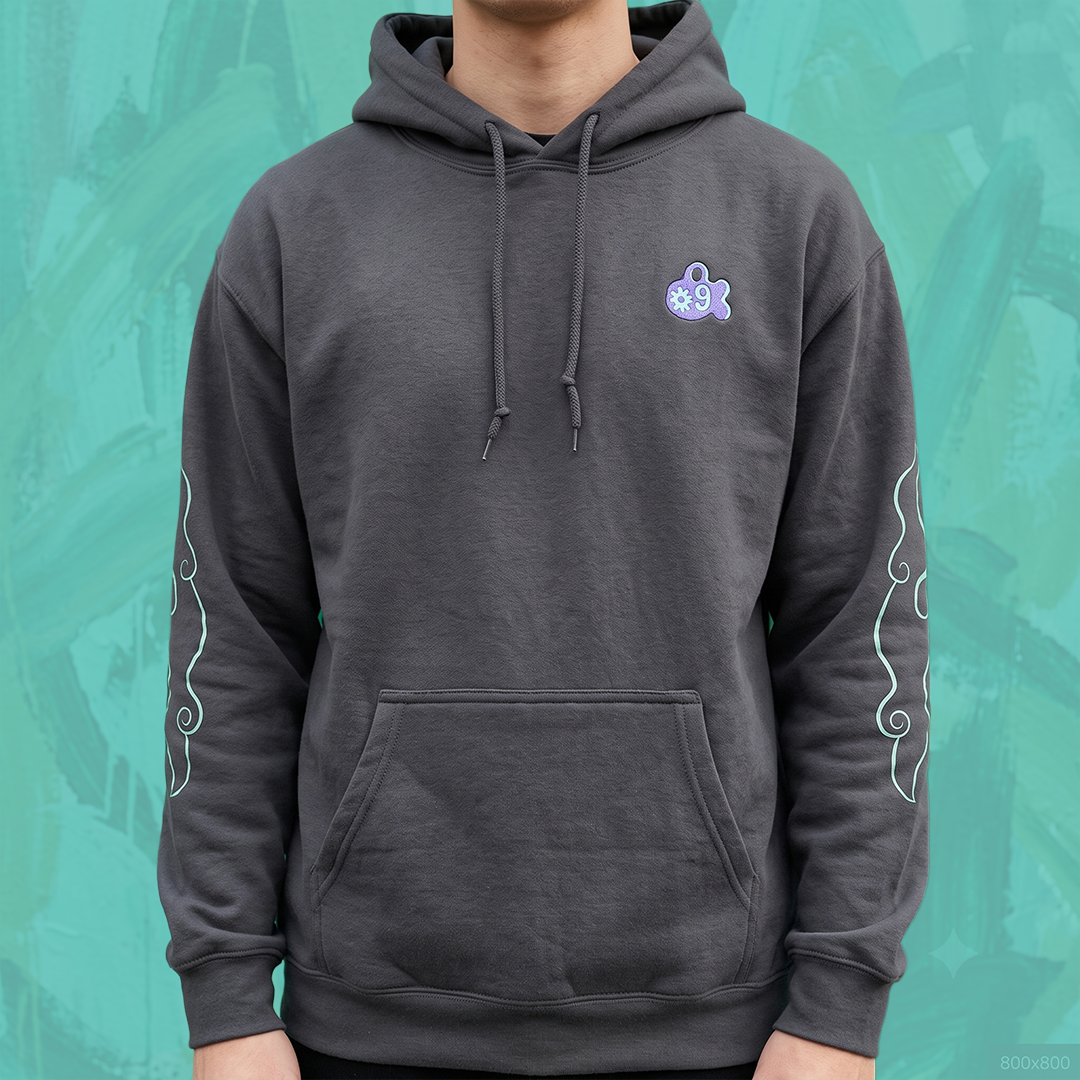 A person wearing a dark gray pullover hoodie with a small icon form Amiko Legends graphic on the left chest and white decorative swirl patterns on both sleeves, set against a textured teal background.