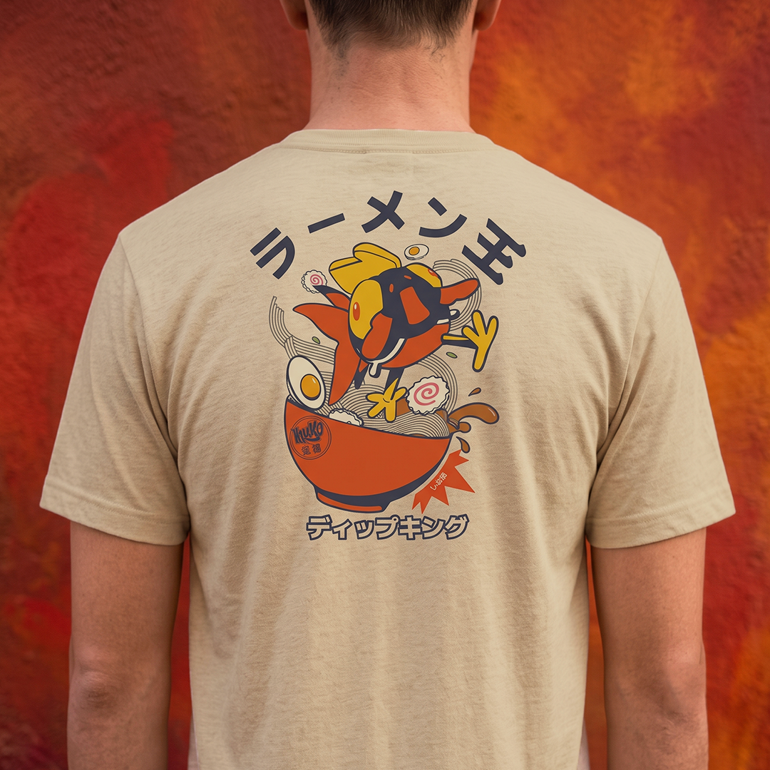 A man viewed from behind wearing a beige t-shirt with a large graphic print on the back. The graphic features a Amiko Lgends character in a ramen bowl with Japanese text above and below, set against a textured orange and red background.